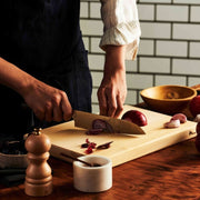 Chef chopping onions with NAGOMI Santoku Knife 180mm crafted by Mitsuboshi Cutlery