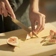 Hands cutting figs with NAGOMI Petty Knife 155mm crafted by Mitsuboshi Cutlery