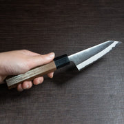 Hand holding Nishida Hamono Polish Petty Knife 100mm