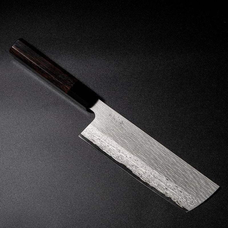 VG XEOS Nakiri Knife 18cm crafted by Nigara Hamono arranged diagonally on black background
