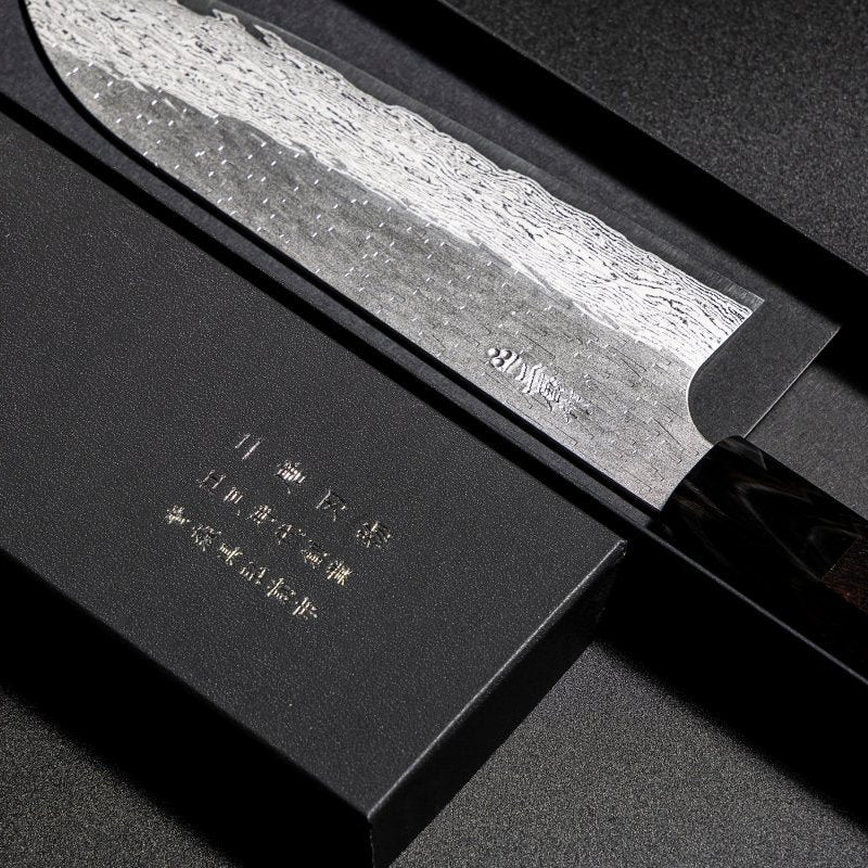 Closeup on engraving on blade of VG XEOS Santoku Knife 18.5cm crafted by Nigara Hamono in elegant box