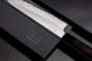 Closeup of engraving on VG XEOS Gyuto Knife 22.5cm crafted by Nigara Hamono in elegant box on black background