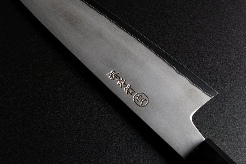Close-up of the brand inscription in Japanese characters on the right side of the blade of a Sakai TAKAYUKI Gyuto 210mm by Aoki Hamono