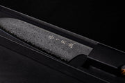 Omoi Santoku stainless steel Kitchen Knife 180mm crafted by Nenohi Cutlery in box zoomed in diagonally