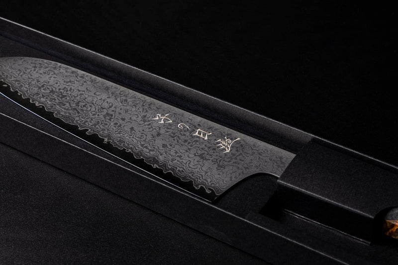 Omoi Santoku stainless steel Kitchen Knife 180mm crafted by Nenohi Cutlery in box zoomed in diagonally