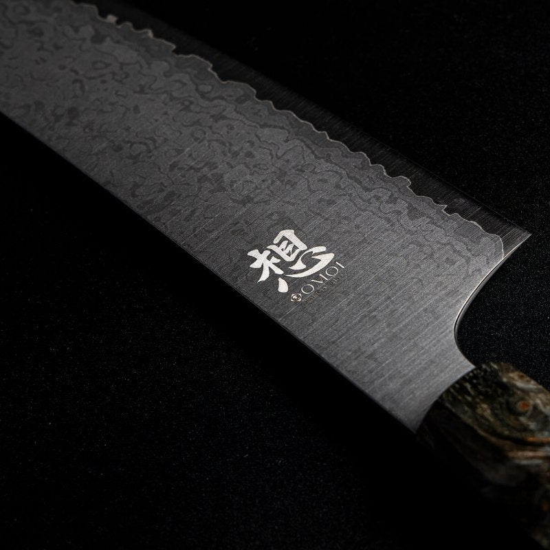 Closeup on blade of Omoi Kiritsuke Santoku stainless steel Kitchen Knife 180mm crafted by Nenohi Cutlery on black background
