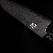 Closeup of back side of blade of Omoi Santoku Kitchen Knife 180mm crafted by Nenohi Cutlery on black background