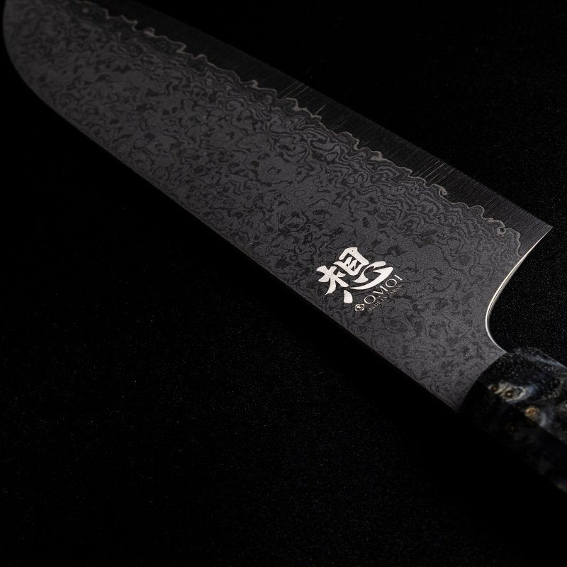 Closeup of back side of blade of Omoi Santoku Kitchen Knife 180mm crafted by Nenohi Cutlery on black background