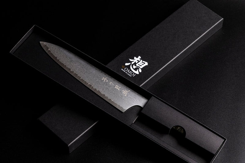 Omoi Gyuto stainless steel Kitchen Knife 180mm crafted by Nenohi Cutlery in sophisticated black box arranged in cross pattern