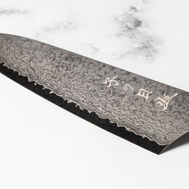 Closeup of front engraving on the blade of Omoi Gyuto stainless steel Kitchen Knife 180mm crafted by Nenohi Cutlery on white background 
