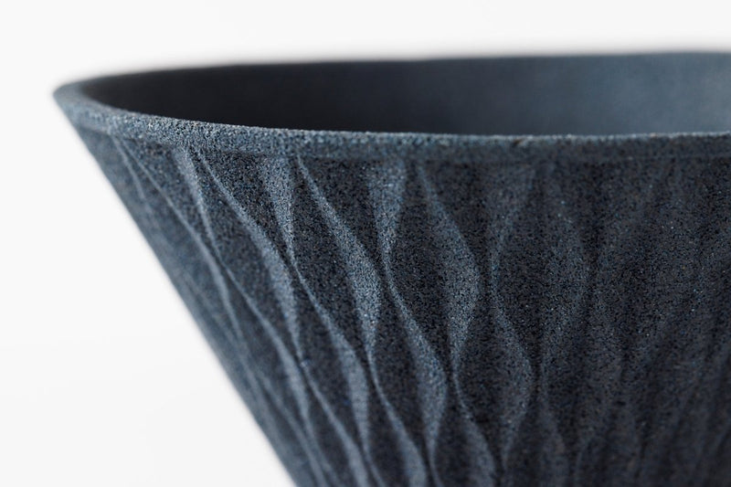 Closeup on upper edge of black COFIL Flow Ceramic Coffee Filter on white background