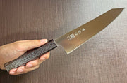 Japanese-style Kiritsuke Santoku Kitchen Knife 21cm crafted by Inoguchi Hamono in Seki, Japan with Japanese Oak handle with black urushi lacquer held in hand