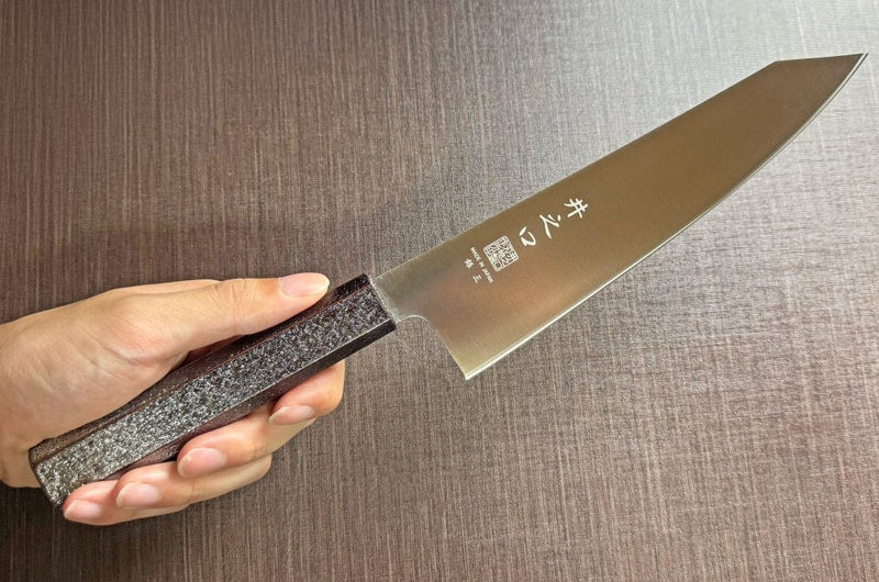 Japanese-style Kiritsuke Santoku Kitchen Knife 21cm crafted by Inoguchi Hamono in Seki, Japan with Japanese Oak handle with black urushi lacquer held in hand