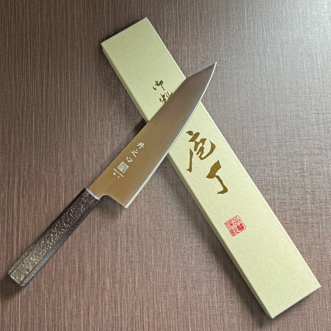 Japanese-style Kiritsuke Santoku Kitchen Knife 21cm crafted by Inoguchi Hamono in Seki, Japan with Japanese Oak handle with black urushi lacquer with box on brown background