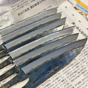 Shigemitsu Hamono blades fresh from the forge on newspaper
