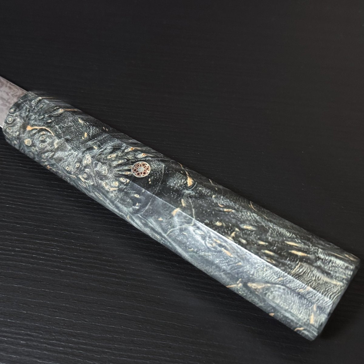 Closeup of handle with Decorative Accent for Omoi Gyuto stainless steel Kitchen Knife 180mm, crafted by Nenohi Cutlery, on black background