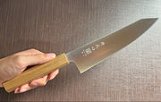 Japanese-style Kiritsuke Santoku Kitchen Knife 21cm crafted by Inoguchi Hamono in Seki, Japan with light brown Japanese Oak handle held in hand