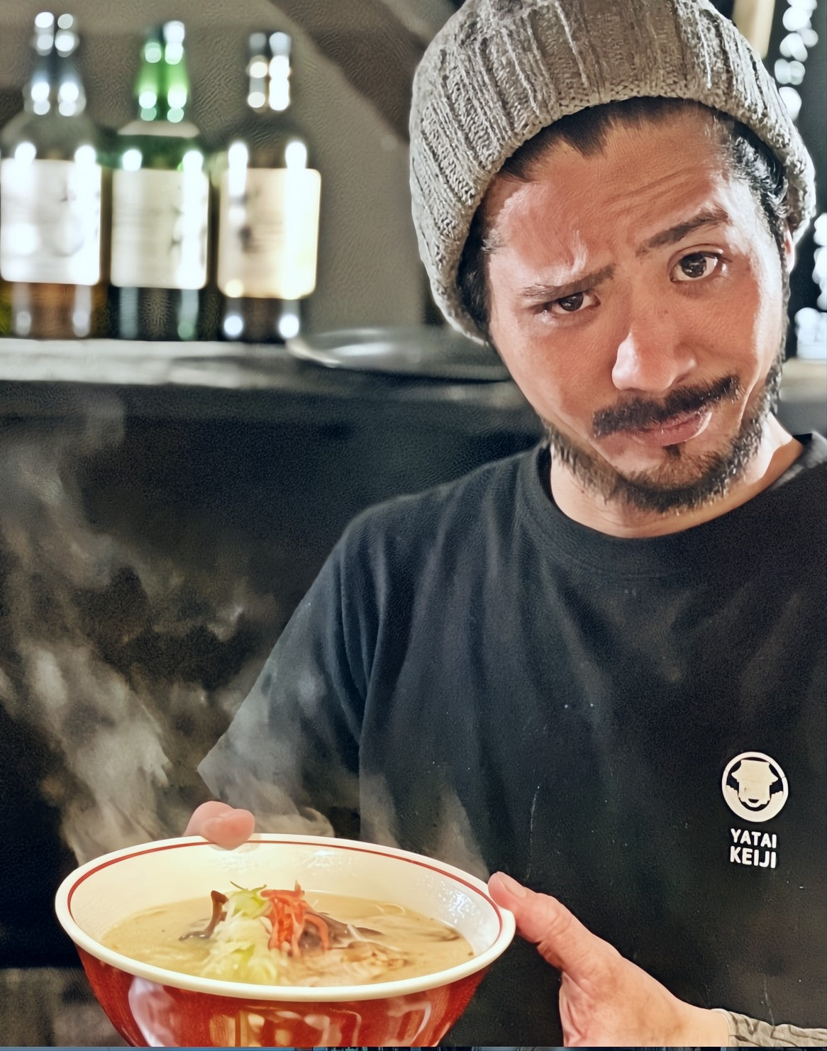 Owner of Yatai Keiji is holding ramen.