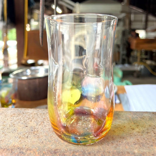 Handcrafted Rainbow Beer Glass by Soejima Glassware on marbled brown surface in workshop