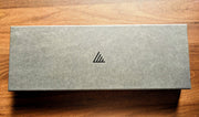 Close-up of the grey box for the Classic Gyuto Kitchen Knife 210mm by Asano Blacksmith in a wooden table