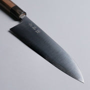Closeup on tip of Sakoda Hamono Polished Aogami Super Gyuto 180mm on grey background