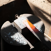 Closeup of a heated metal bar in the hammering station inside Kabayama Blacksmith workshop