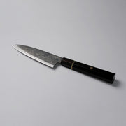 Shirou Kunimitsu Special White Steel Kurouchi Santoku Knife 170mm (Ebony Wood Handle) on a grey background