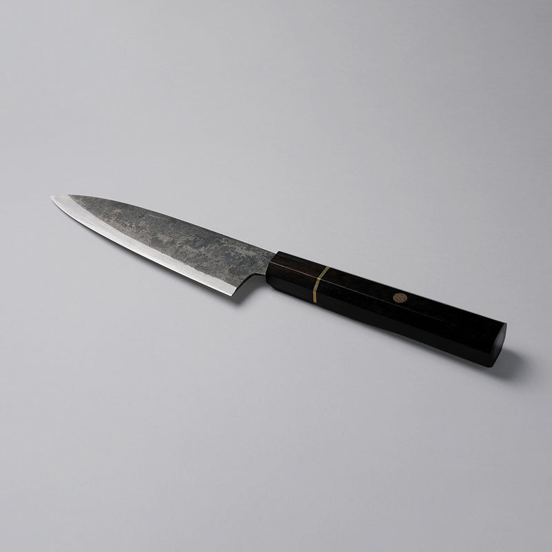 Shirou Kunimitsu Special White Steel Kurouchi Santoku Knife 170mm (Ebony Wood Handle) on a grey background