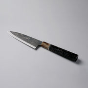 Shirou Kunimitsu Special White Steel Kurouchi Santoku Knife 170mm (Golden Leaf Ebony Handle) on a grey background