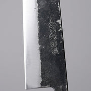 Closeup on an engraving of the smithy on Minomo Blacksmith Santoku Knife 165mm