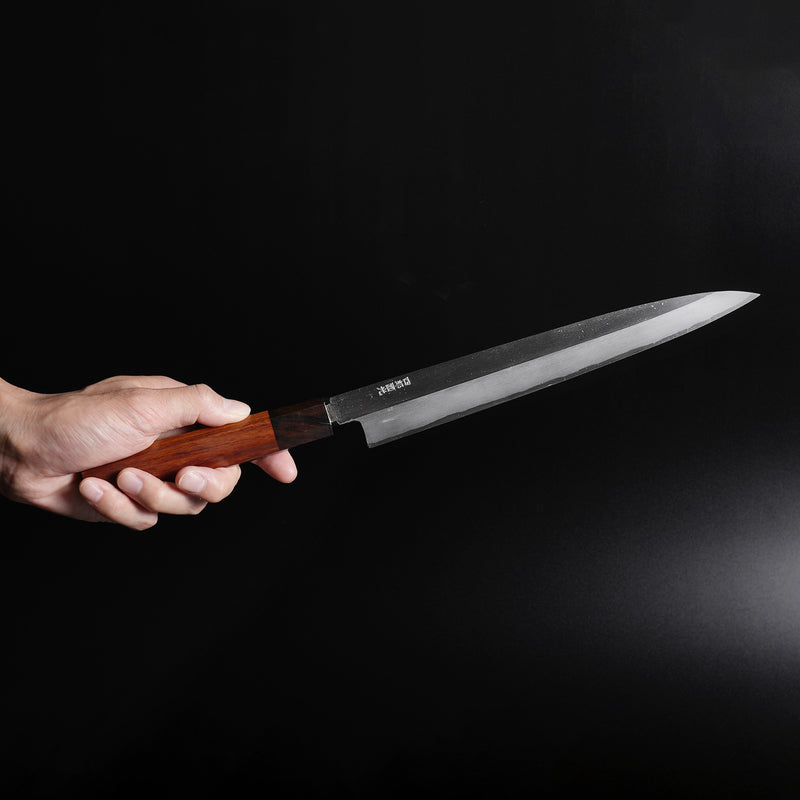 Hand holding a Shirou Kunimitsu White Steel Kasumi Sashimi Knife 230mm