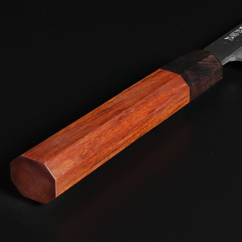 Closeup of the red handle of a Shirou Kunimitsu White Steel Kasumi Sashimi Knife 230mm