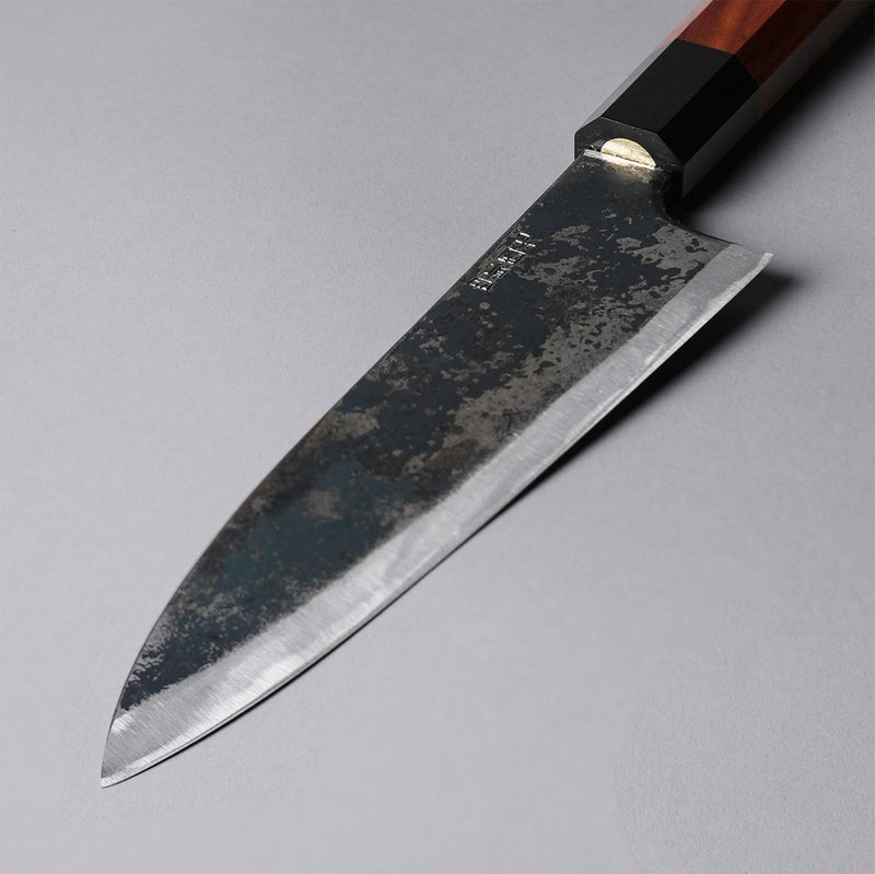Closeup of the blade of a Shirou Kunimitsu Special White Steel Kurouchi Santoku Knife 170mm (Red Handle) 