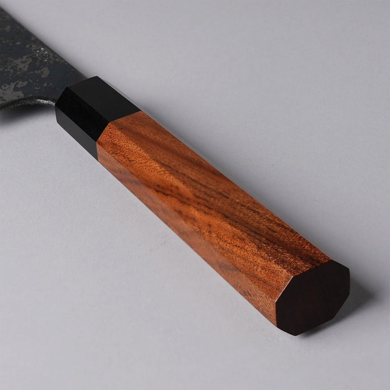 Closeup of the red handle of a Shirou Kunimitsu Special White Steel Kurouchi Santoku Knife 170mm