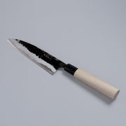 Kurouchi Santoku Knife 165mm crafted by Nakamura Blacksmith displayed diagonally on grey background