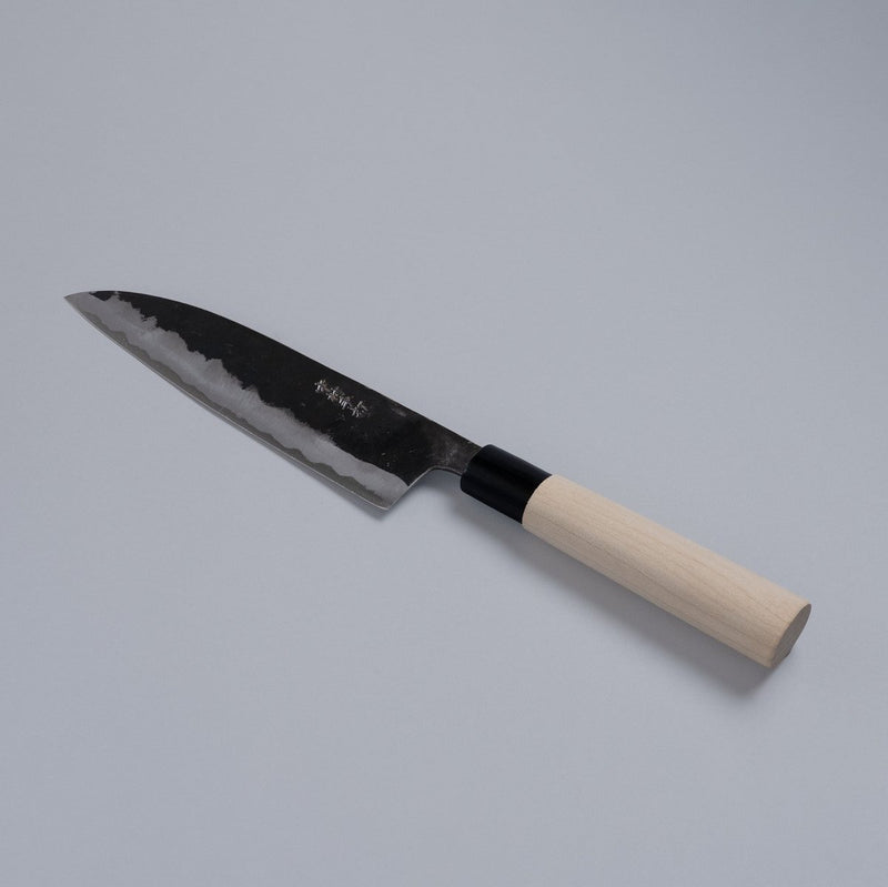 Kurouchi Santoku Knife 180mm crafted by Nakamura Blacksmith displayed diagonally on grey background