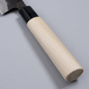 Closeup on handle of Kurouchi Santoku Knife 165mm crafted by Nakamura Blacksmith on grey background