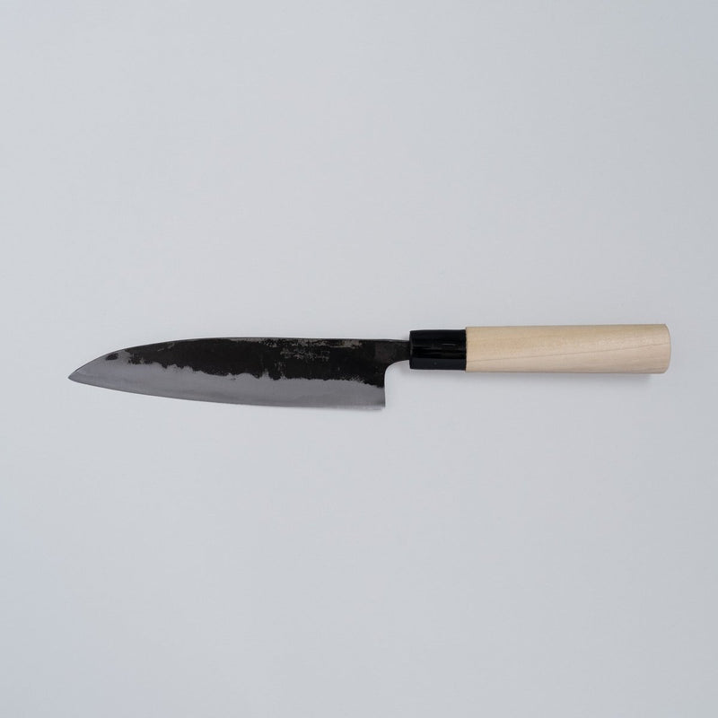 Kurouchi Santoku Knife 165mm crafted by Nakamura Blacksmith displayed horizontally on grey background
