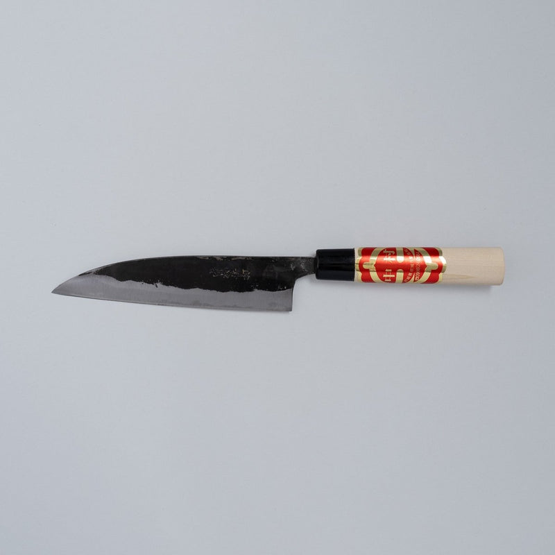 Kurouchi Santoku Knife 150mm crafted by Nakamura Blacksmith displayed horizontally on grey background