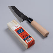 Nakamura Hamono Curved Back Bunka Kitchen Knife 165mm next to the free Amakusa red natural whetstone on a grey background