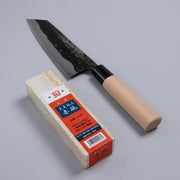 Nakamura Hamono Bunka Kitchen Knife 180mm next to the free Amakusa red natural whetstone on a grey background