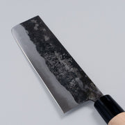 Closeup of the blade of a Nakamura Hamono Kurouchi Nakiri Knife 170mm with maker's name engraved