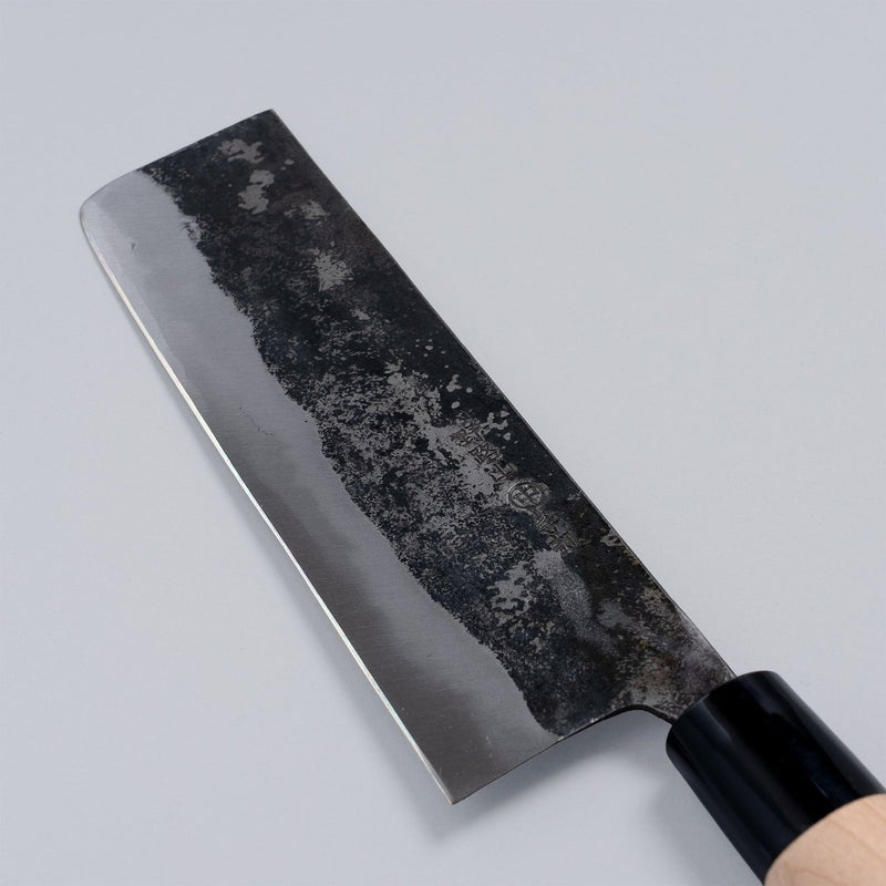 Closeup of the blade of a Nakamura Hamono Kurouchi Nakiri Knife 170mm with maker's name engraved
