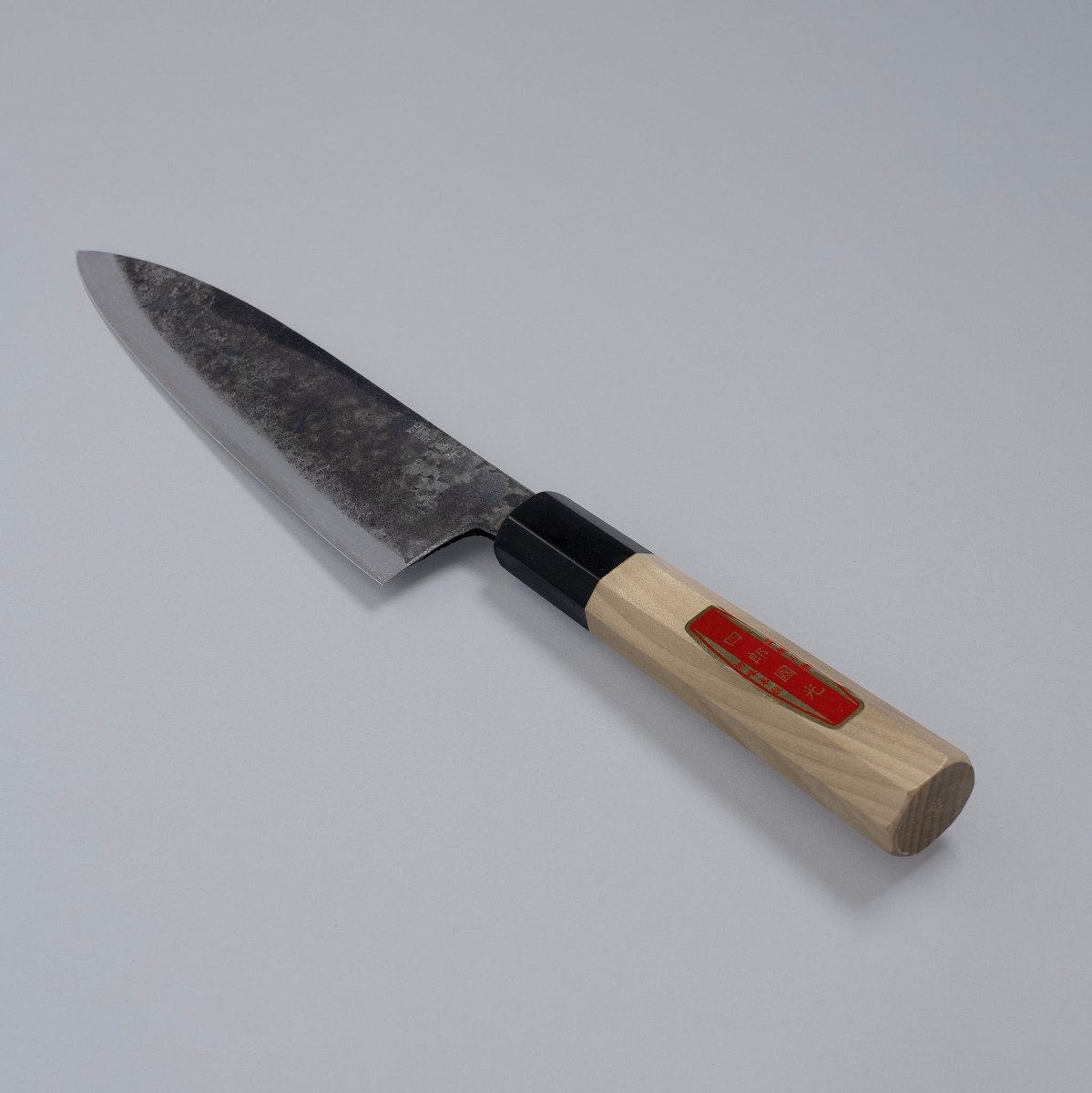 Special Kurouchi Vegetable Funayuki Knife 170mm crafted by Shirou Kunimitsu displayed diagonally on grey background