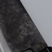 Closeup on engraving on Single-Bevel Kurouchi Nakiri Knife 160mm crafted by Shirou Kunimitsu on grey background