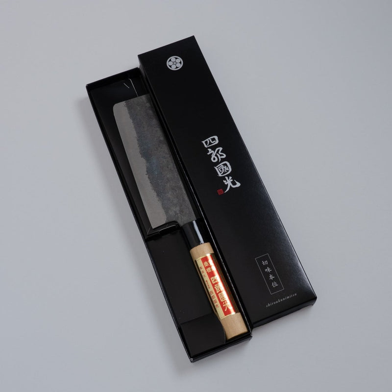 Single-Bevel Kurouchi Nakiri Knife 160mm crafted by Shirou Kunimitsu in black box on grey background