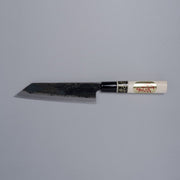 Kurouchi Santoku knife 160mm crafted by Shigemitsu Hamono displayed horizontally on grey background 