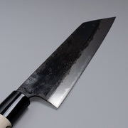 Closeup on blade of Kurouchi Santoku knife 160mm crafted by Shigemitsu Hamono displayed diagonally on grey background 