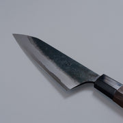 Closeup of the blade of a Nishida Hamono Kurouchi Gyuto Knife 165mm with maker's name engraving