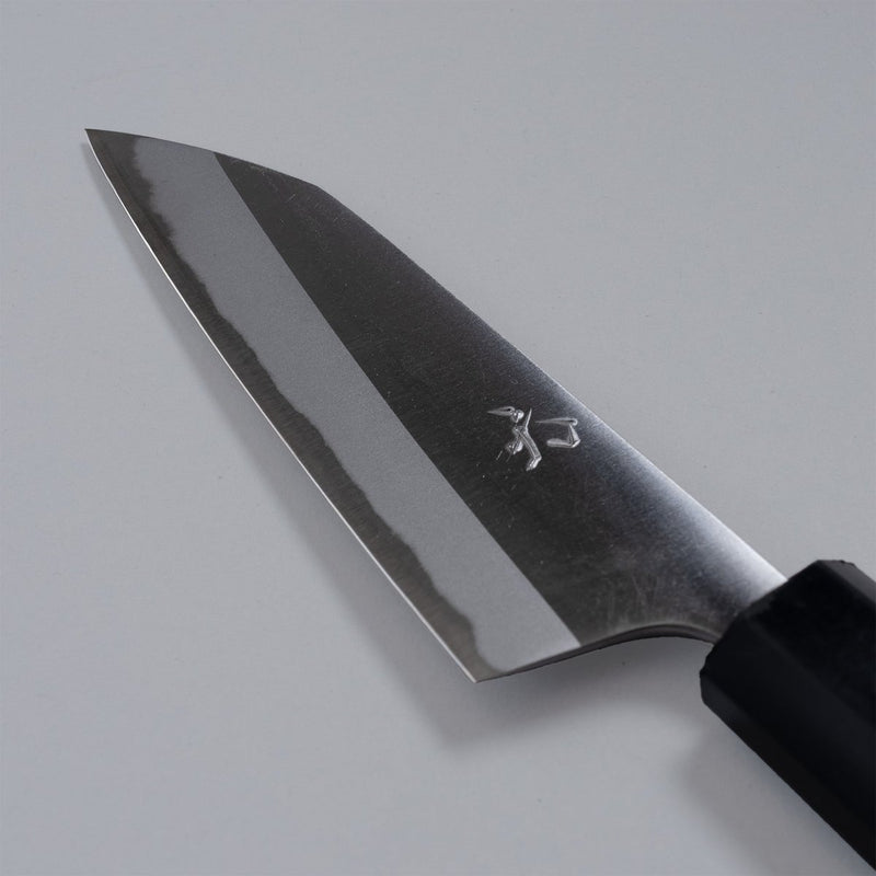 Closeup of the blade of a Nishida Hamono Polished Petty Knife 100mm with maker's engraving